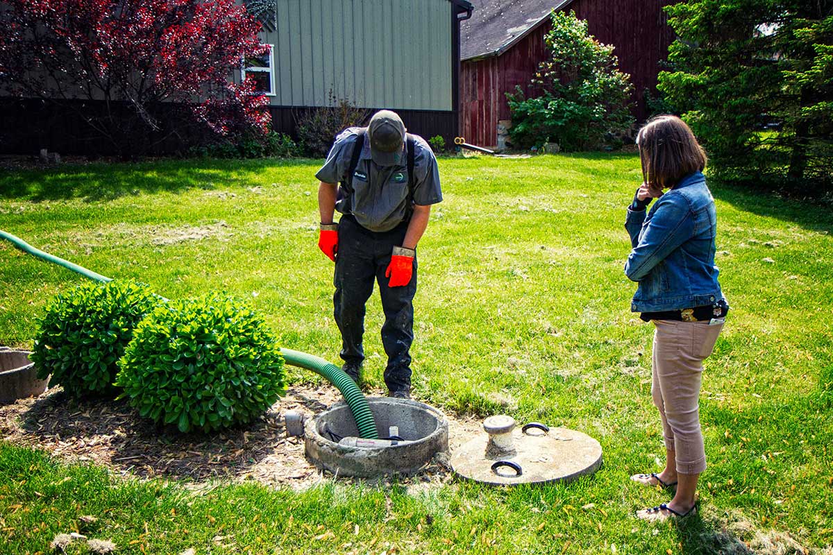 Man Checking the Septic with Client Observing — Clyman, WI — United Septic & Drain Services Inc