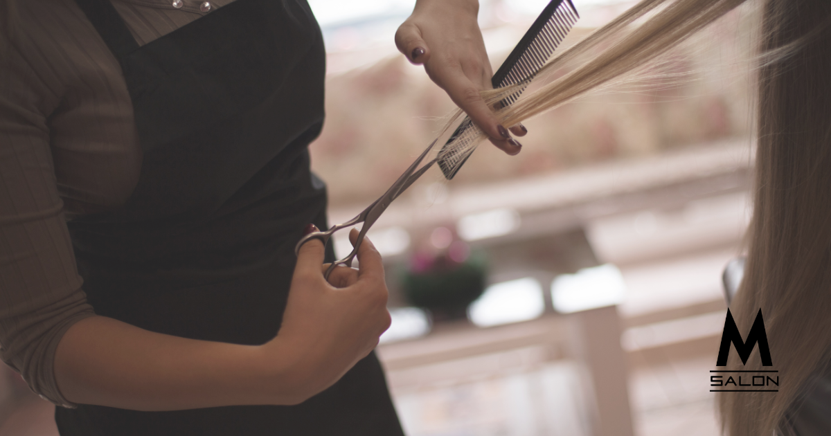 A close up of a person holding a pair of scissors.