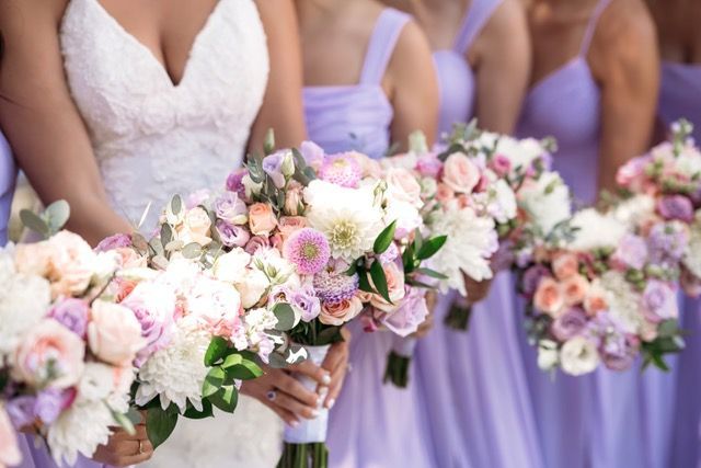 A bouquet of pink roses and white flowers on a table