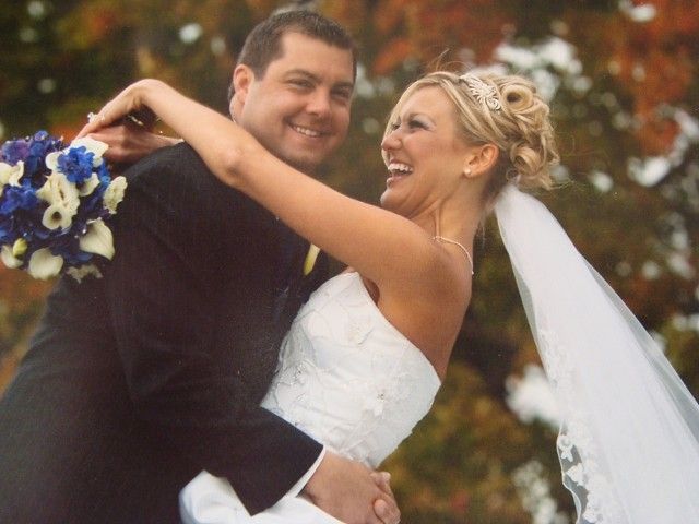 A bride and groom are posing for a picture on their wedding day
