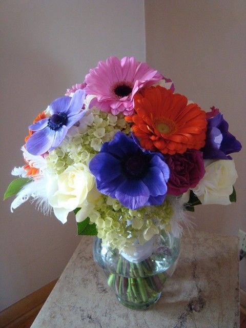 A vase filled with colorful flowers sits on a table