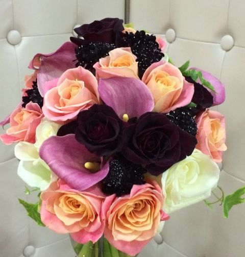 A bouquet of pink and purple flowers in a vase