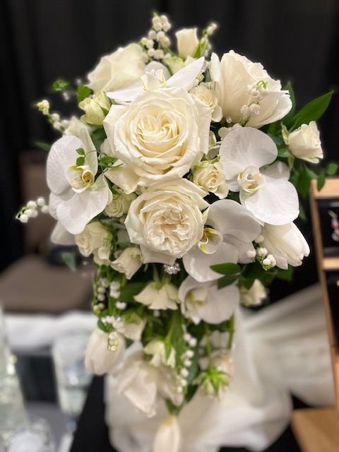 A bouquet of white flowers is sitting on a table.