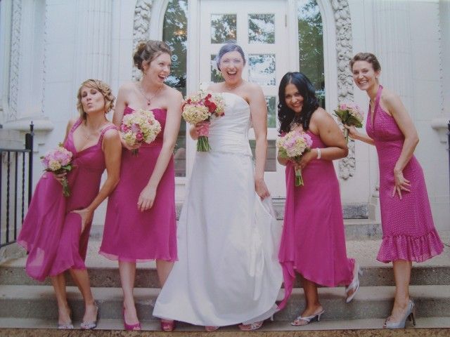 A bride and her bridesmaids are posing for a picture