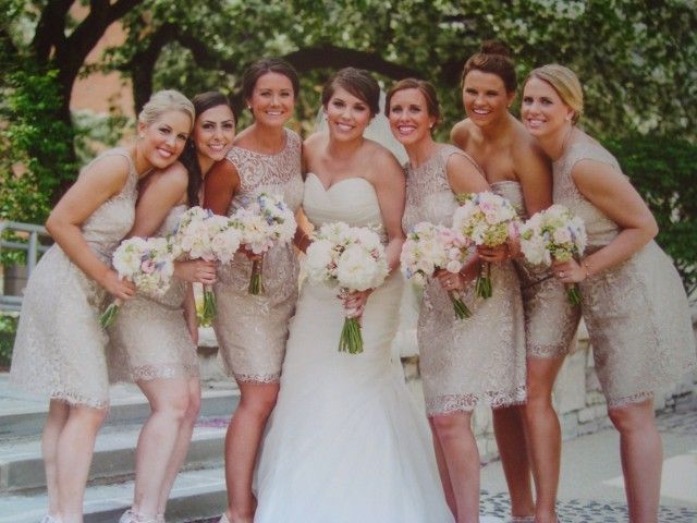A bride and her bridesmaids are posing for a picture.