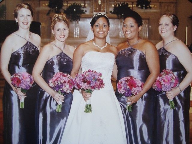 A bride and her bridesmaids pose for a photo