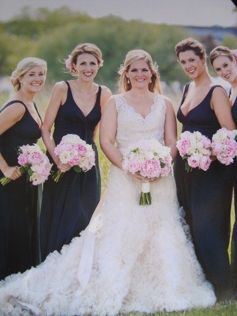 A bride and her bridesmaids pose for a photo