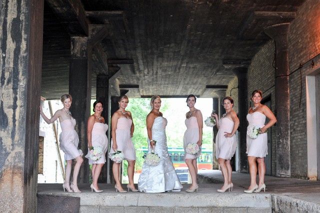 A bride and her bridesmaids are posing for a picture