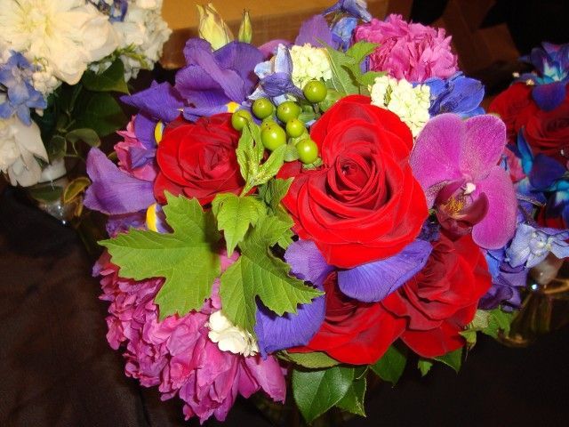A bouquet of red purple and blue flowers on a table