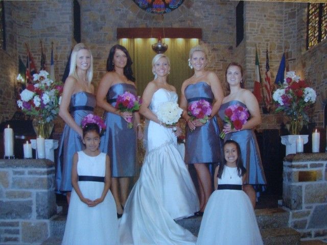 A bride and her bridesmaids pose for a photo