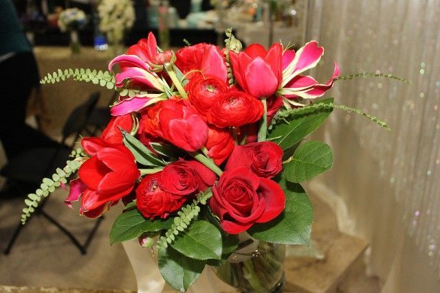 A bouquet of red flowers in a vase on a table