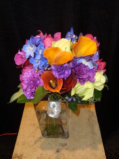 A vase filled with colorful flowers sits on a table