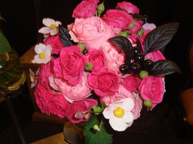 A bouquet of pink roses and white flowers on a table