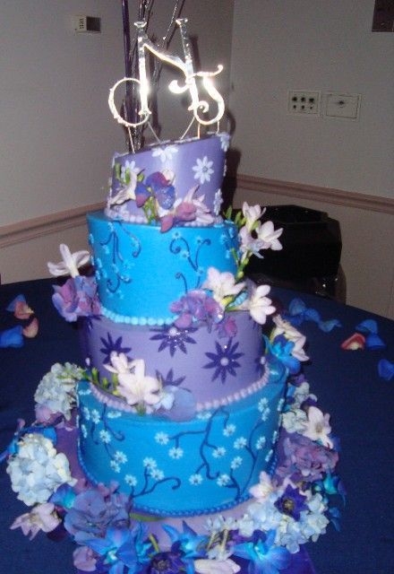A blue and purple cake with the letters ns on top