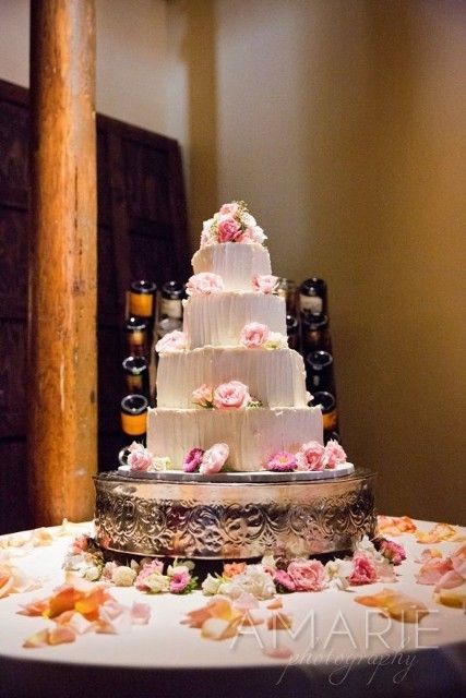 A wedding cake on a table with the word marie on the bottom