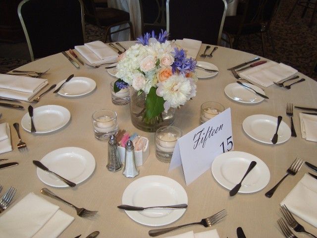 A table with plates and silverware and a sign that says fiftieth