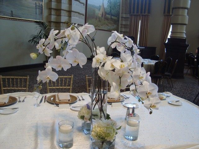 A table with flowers and candles on it