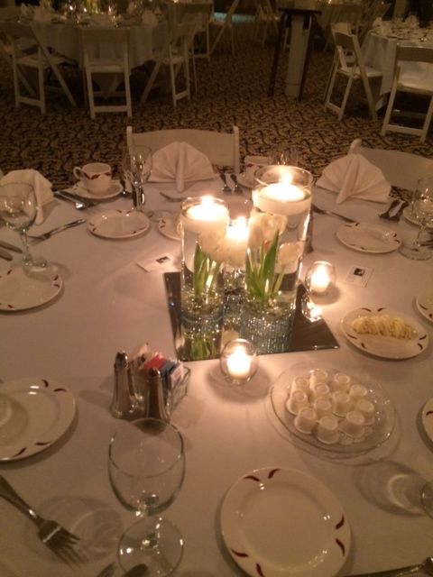 A table with candles and flowers on it