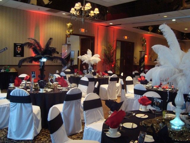 A room filled with tables and chairs with feathers on them