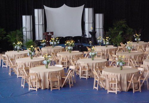 A large room with tables and chairs set up for a party