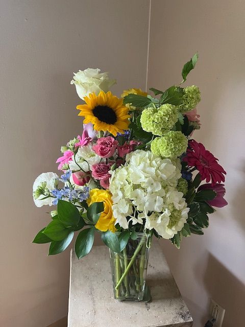 A vase filled with flowers is sitting on a table.