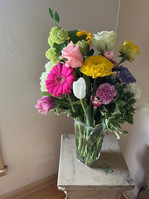 A vase filled with flowers is sitting on a table.