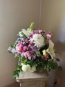 A vase filled with flowers is sitting on a table.