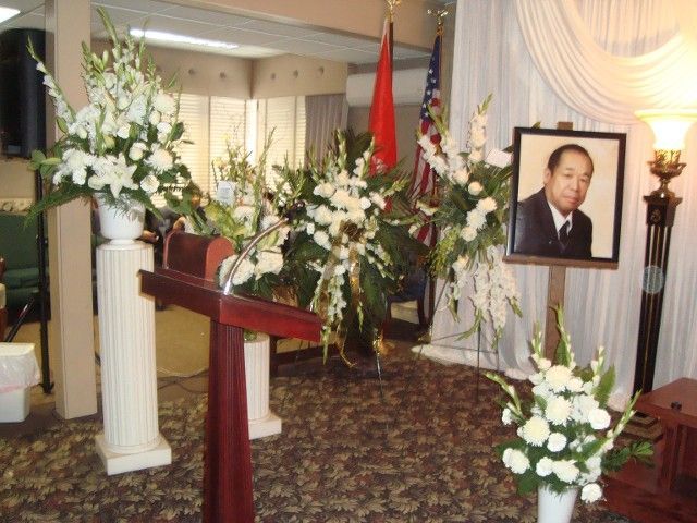 A podium with flowers and a picture of a man on it