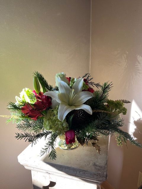 A vase filled with flowers is sitting on a table.