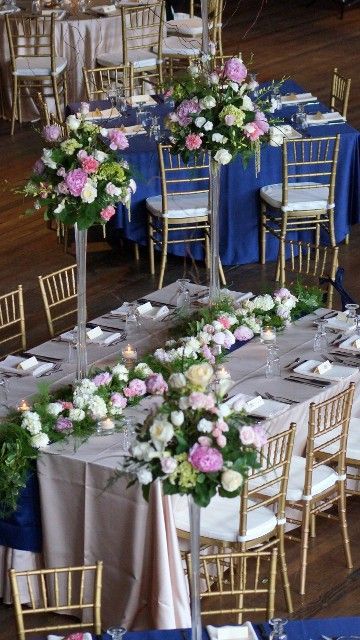A table set for a wedding reception with flowers on it