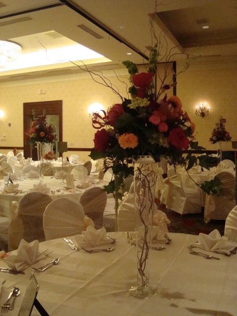 A vase filled with flowers sits on a table