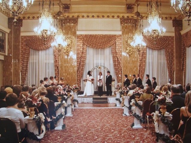 A bride and groom are getting married in front of a crowd