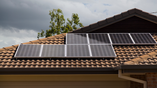 A row of solar panels on the roof of a house