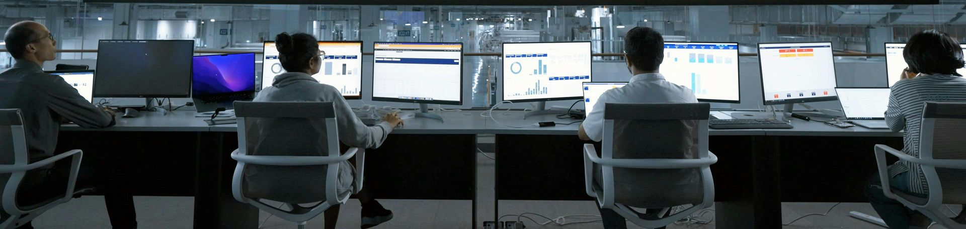 People sitting at desks reviewing systems automation.