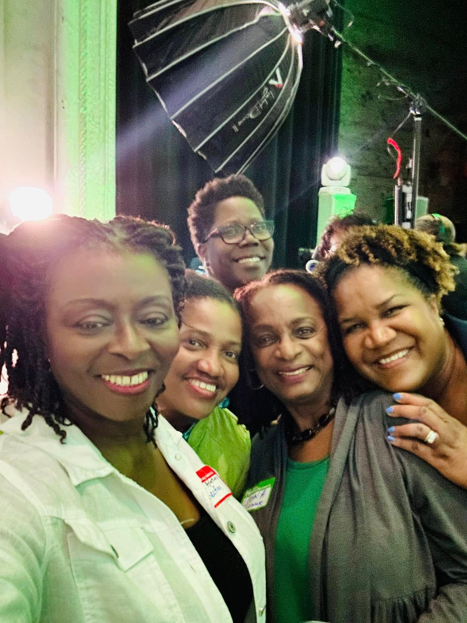 A group of women are posing for a picture together