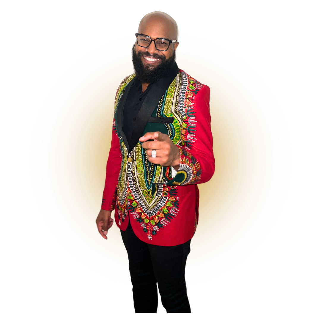A man with a beard and glasses is wearing a red jacket and black pants.