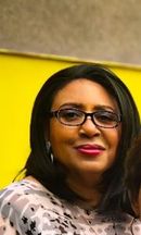 A woman wearing glasses and pink lipstick is holding a child.