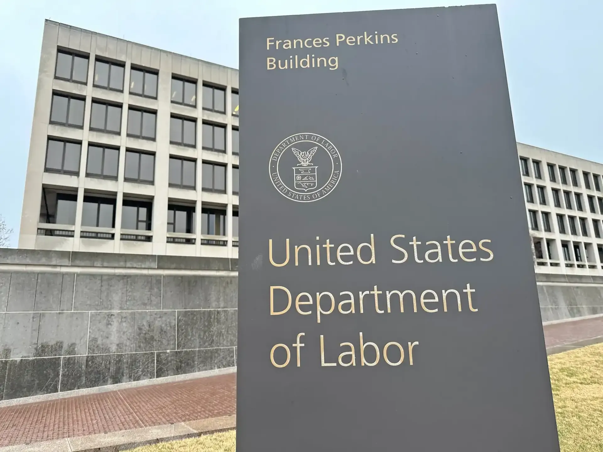A united states department of labor sign in front of a building