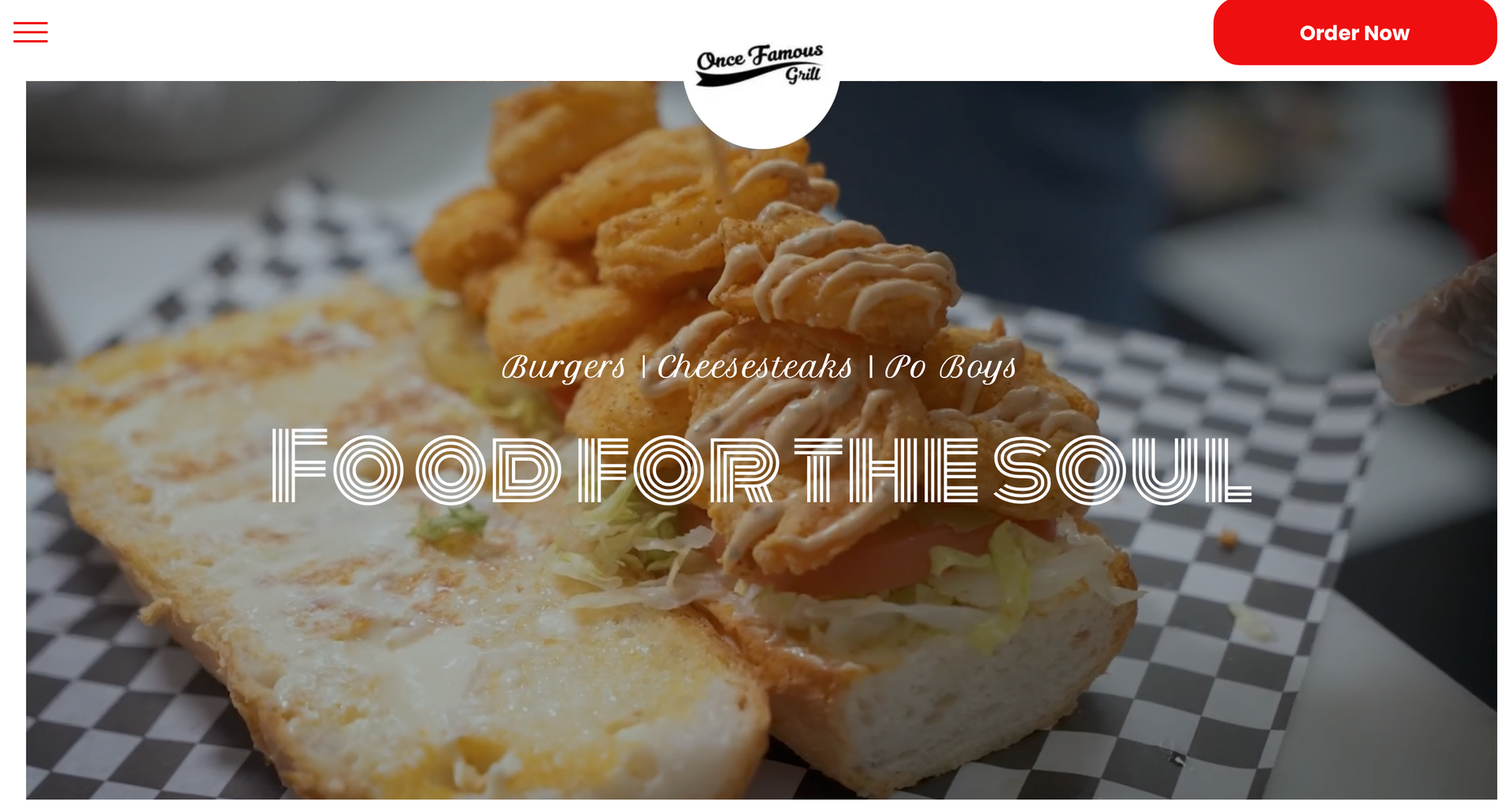 Sandwich piled high with fried food, black and white checkered paper. 