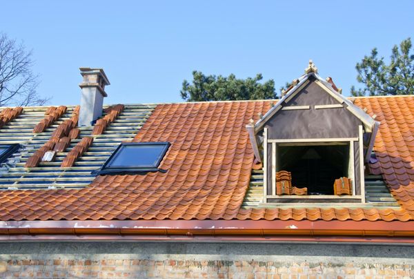 the roof of a house with a small window