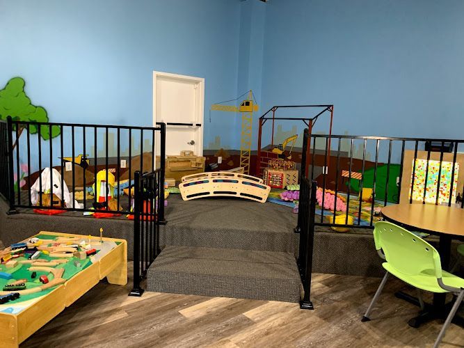 A room filled with lots of toys and tables and chairs.