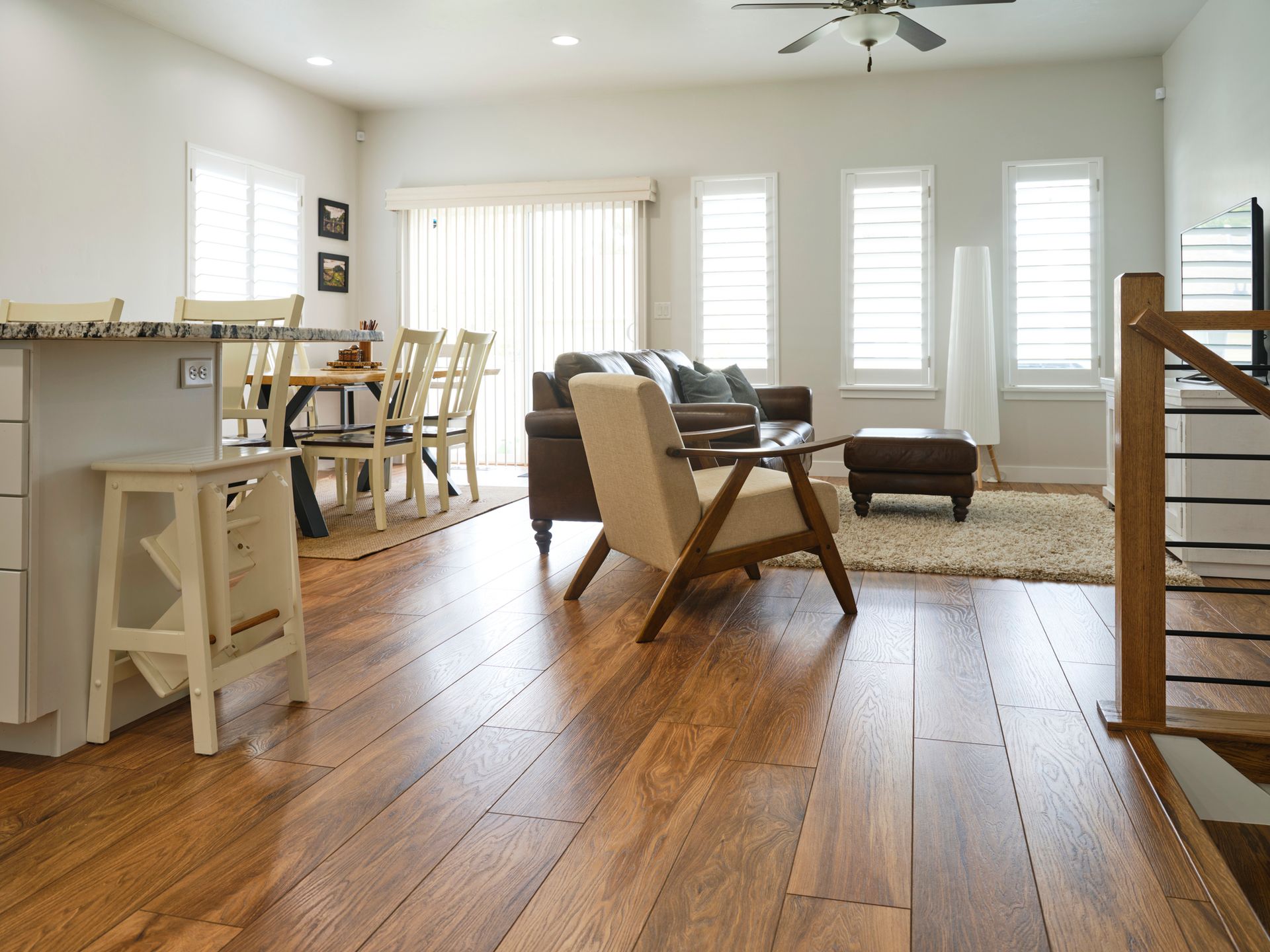 Spacious living room with hardwood floors, dining area, and modern furniture.