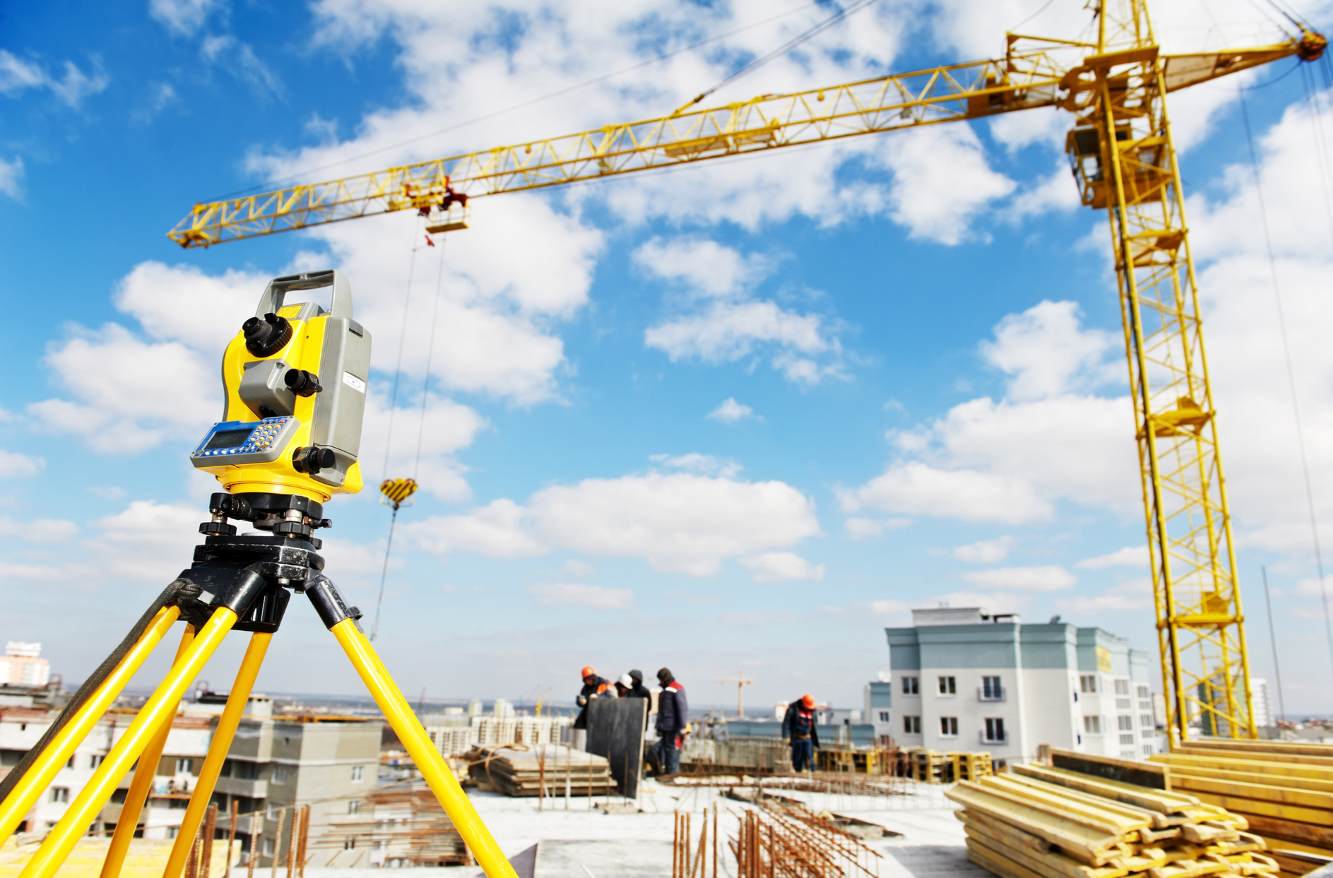 A construction site with a yellow crane in the background