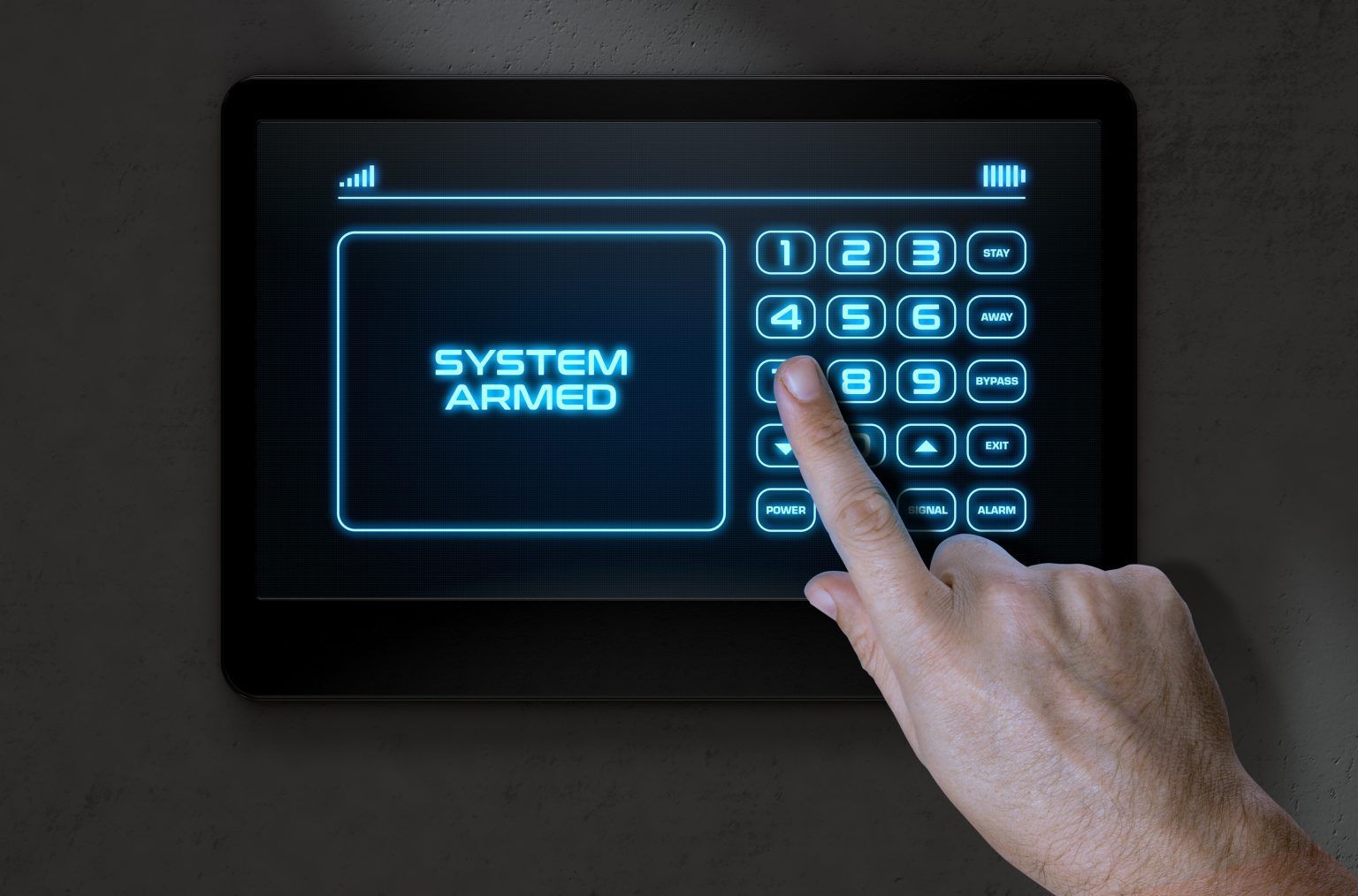 A person is pressing a button that says System Armed – Sacramento, CA – First Solutions Incorporated