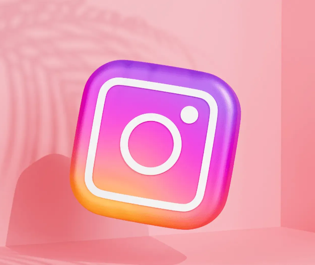 Logo Instagram 3D sur fond rose avec ombre.