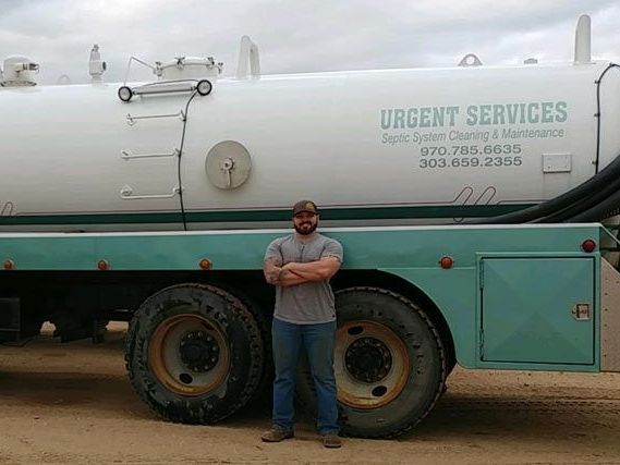 a man is standing in front of a large white truck .