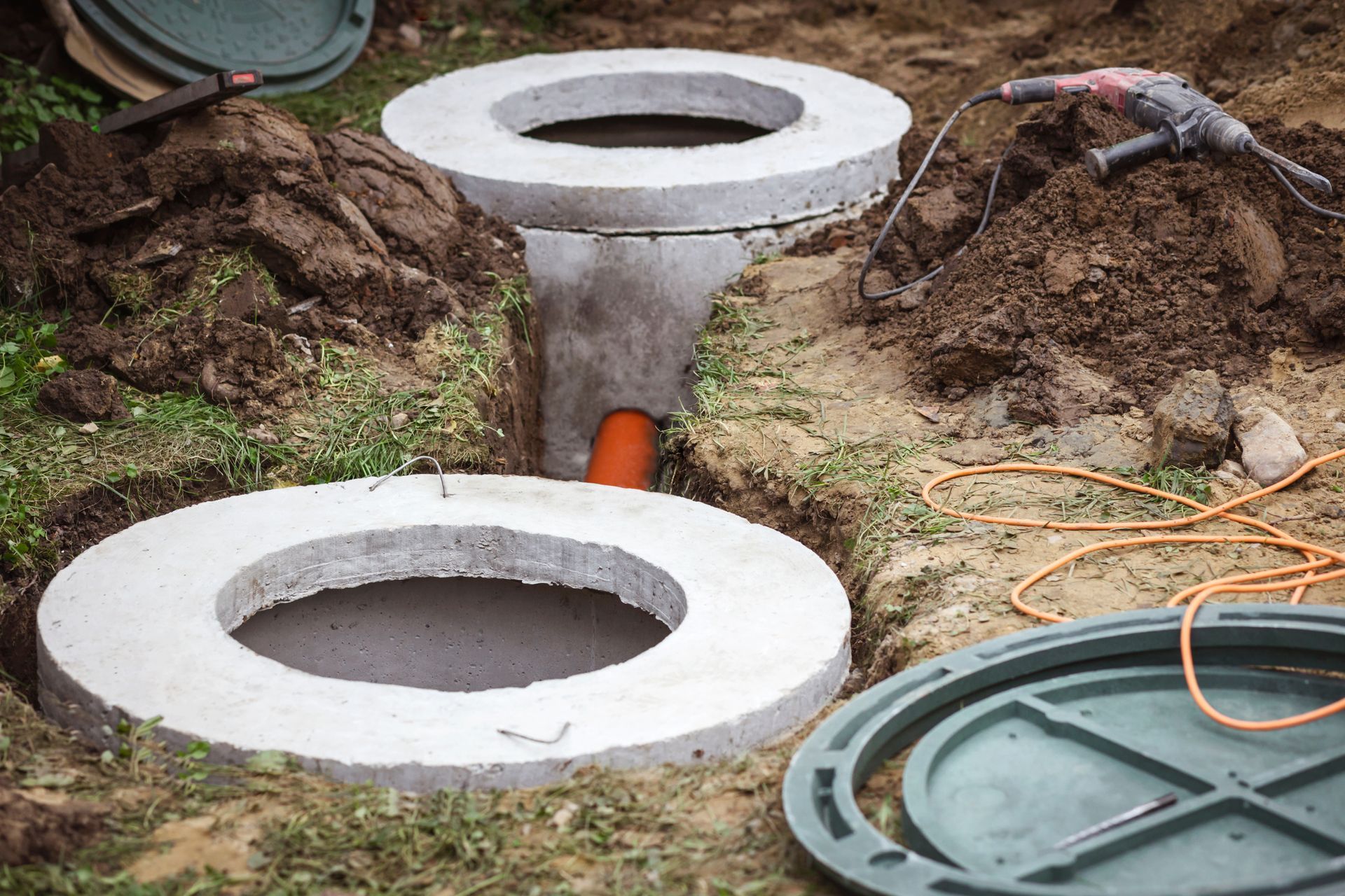 a concrete septic tank is being built in the dirt .