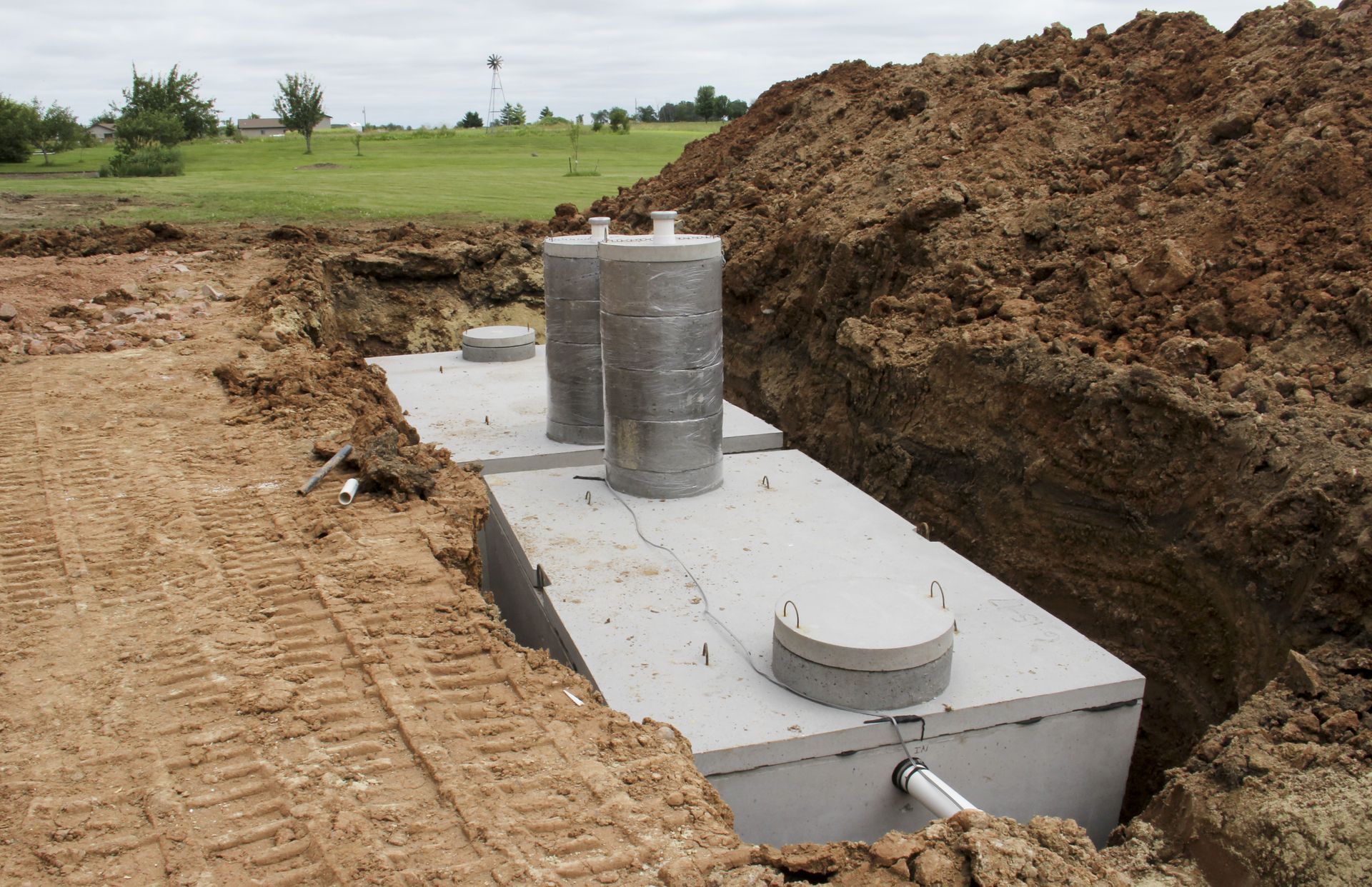 a septic tank is being built in a dirt field