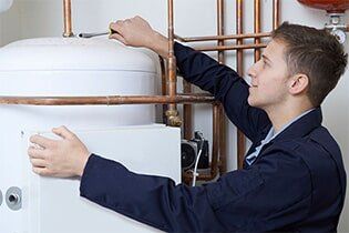 Working On Central Heating Boiler - Plumbing Repair in Yorkville, IL
