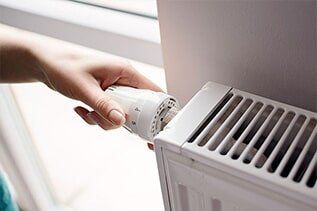 Hand Adjusting Thermostat - Plumbing Repair in Yorkville, IL